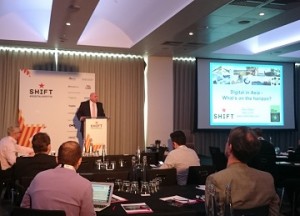 A photograph of Mike Millar giving his presentation on digital business in Asia, to a room of attendees at Shift London.