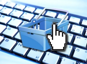 A graphic of a shopping basket juxtaposed against a keyboard, with a pointing finger mouse icon hovering over the top.