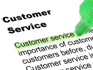A picture of a piece of paper with the definition of "Customer service" partially visible. A green highlighter rests against the page, having highlighted the words "Customer service".